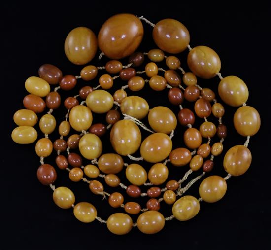 A large single strand graduated oval amber bead necklace,